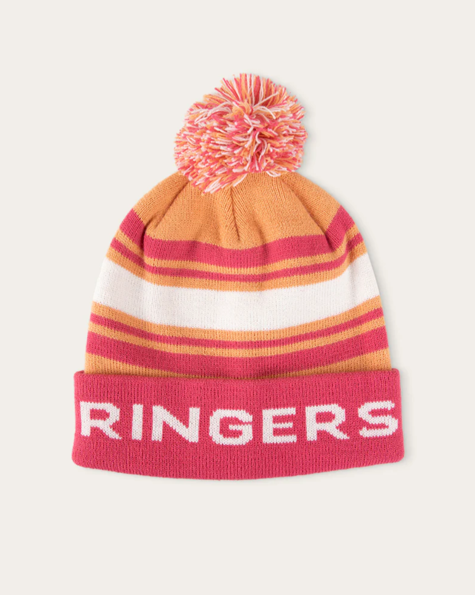 A pink, orange, and white striped beanie with a multi-colored pom-pom on top, and the word 'Ringers' written across the front.