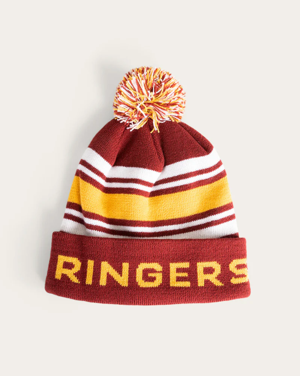 A maroon, white, and gold striped beanie with a multi-color pom-pom on top, and the word 'Ringers' written across the front.