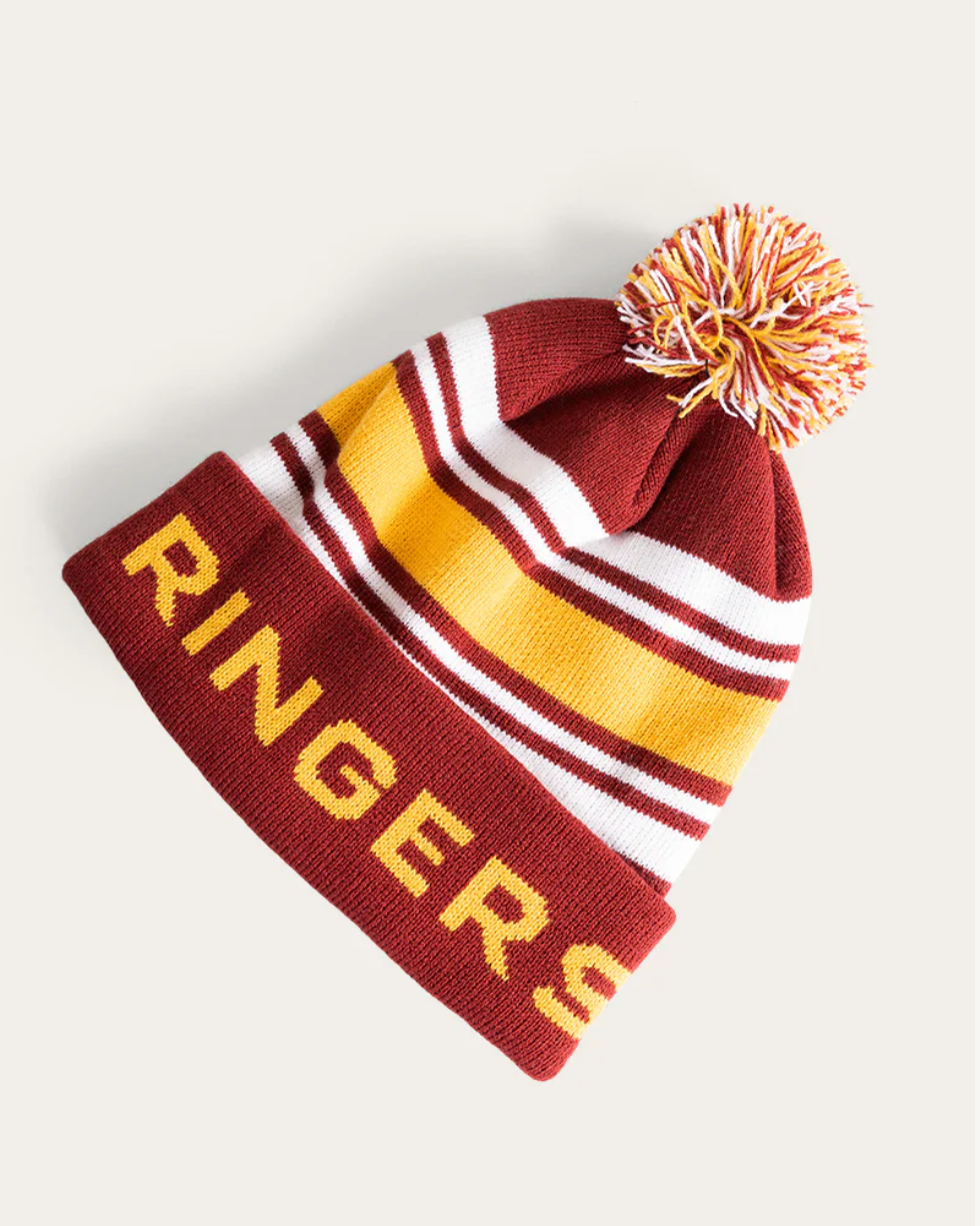 Beanie with pom-pom and 'Ringers' text on a plain background