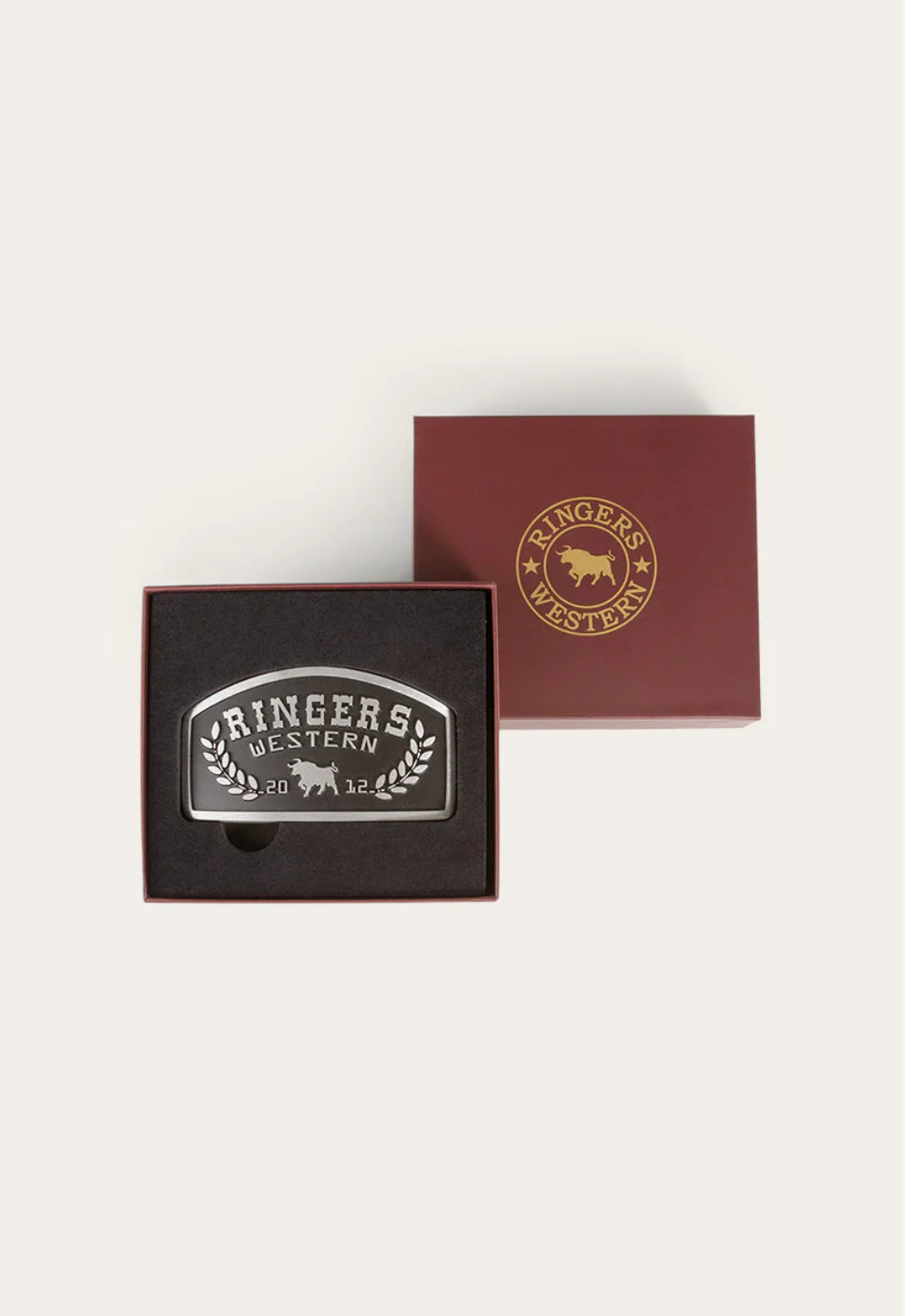 Belt buckle and packaging with 'Ringer's Western' branding on a white background