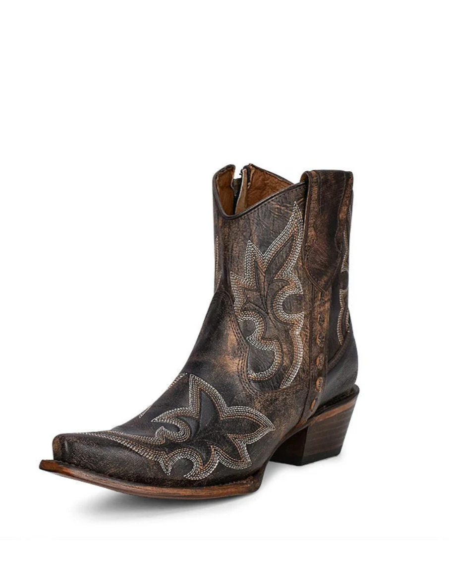Brown cowboy boot with intricate patterns on a white background
