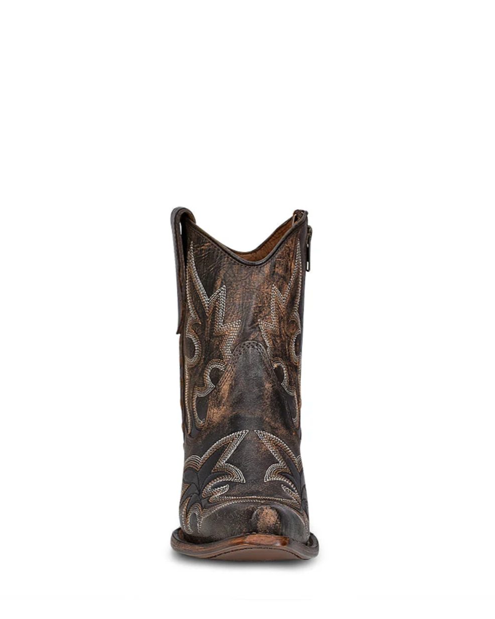 Brown cowboy boot with intricate patterns on a white background