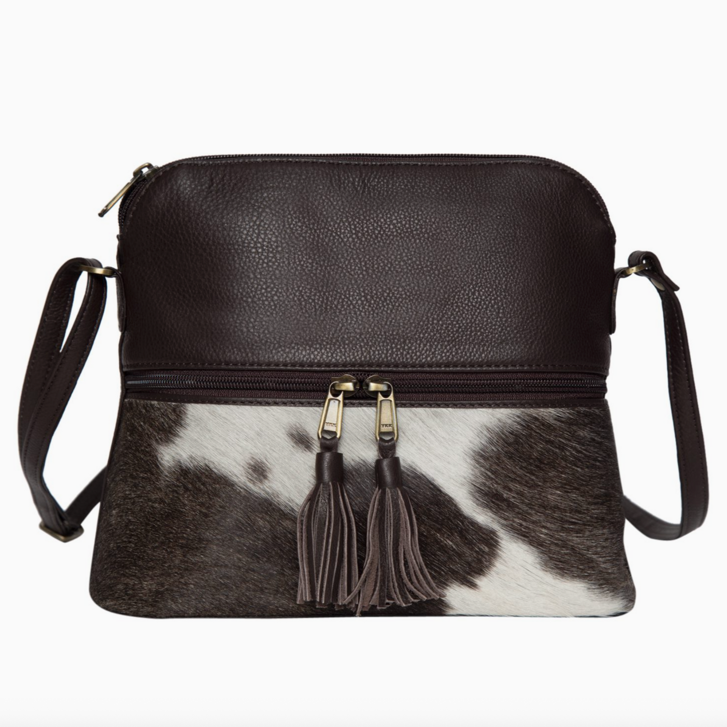Black leather crossbody bag with cowhide pattern and tassels on a white background