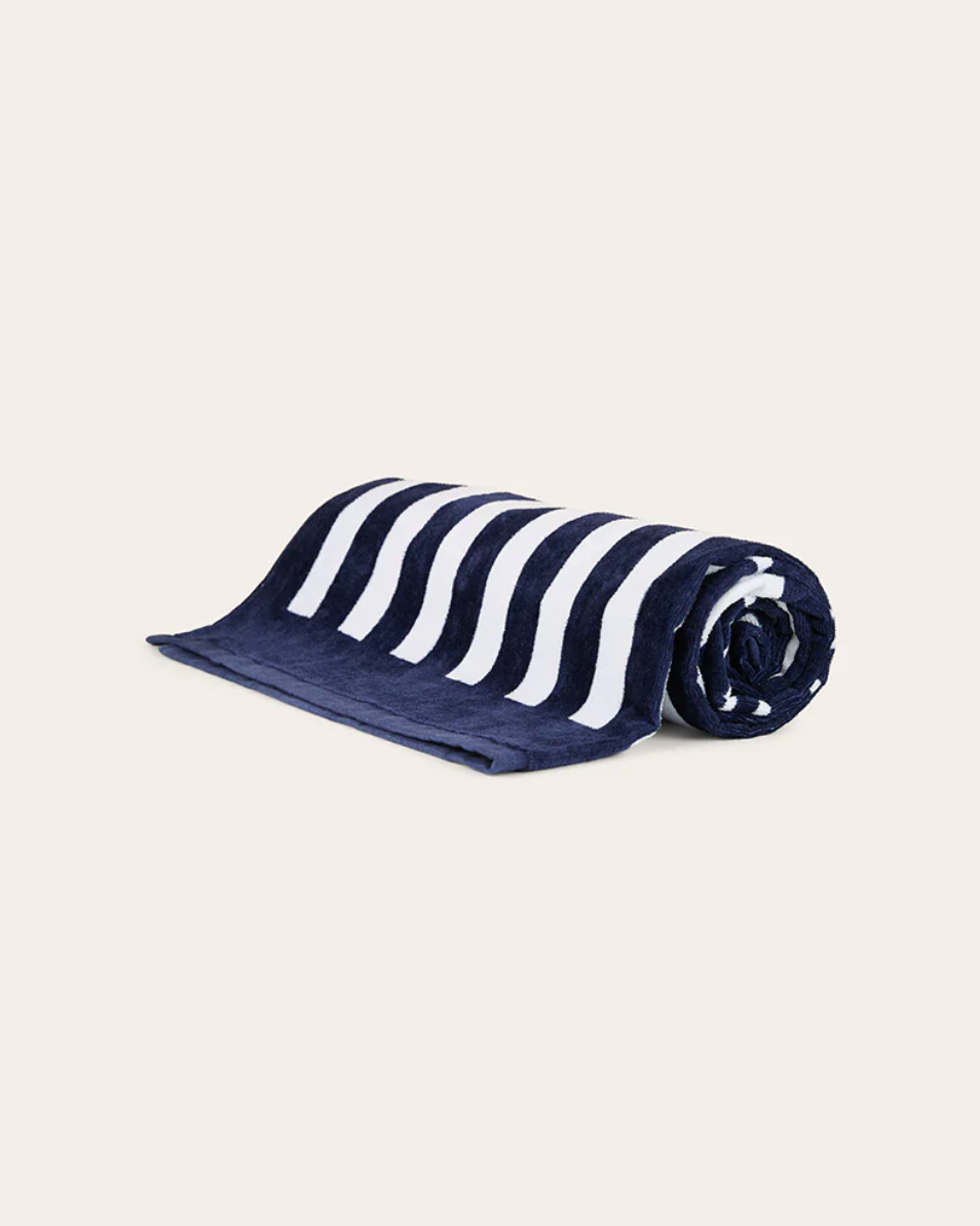 Navy and white striped towel on a beige background