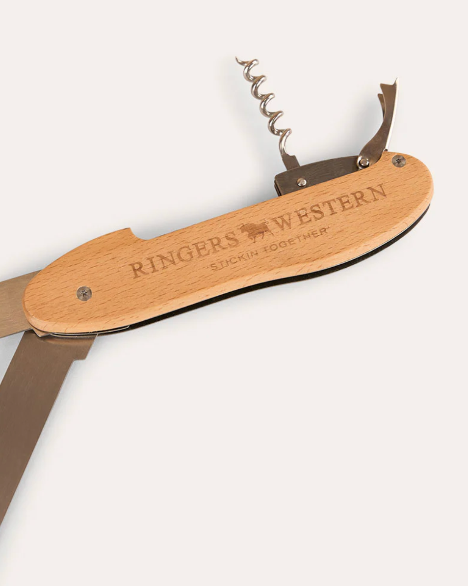 Wooden multi-tool with corkscrew and knife on a white background, branded 'Ringers Western'.