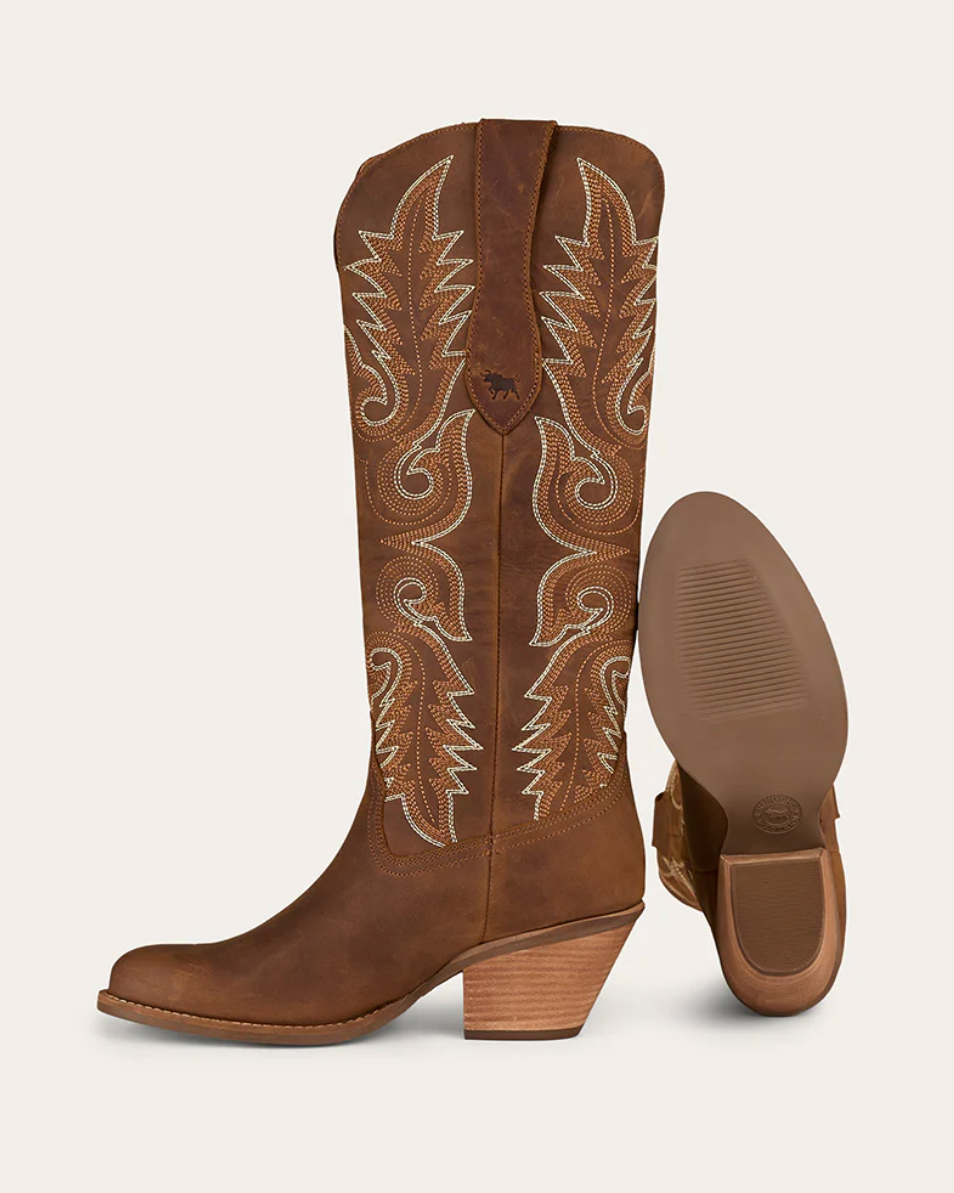 Brown cowboy boot with intricate white embroidery on a white background