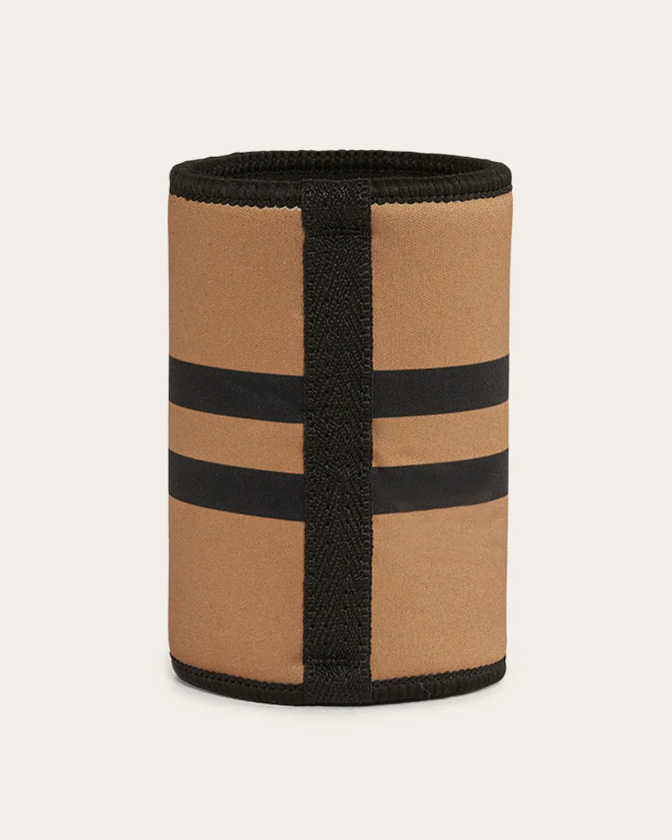 Beige and black striped cylindrical object on a beige background