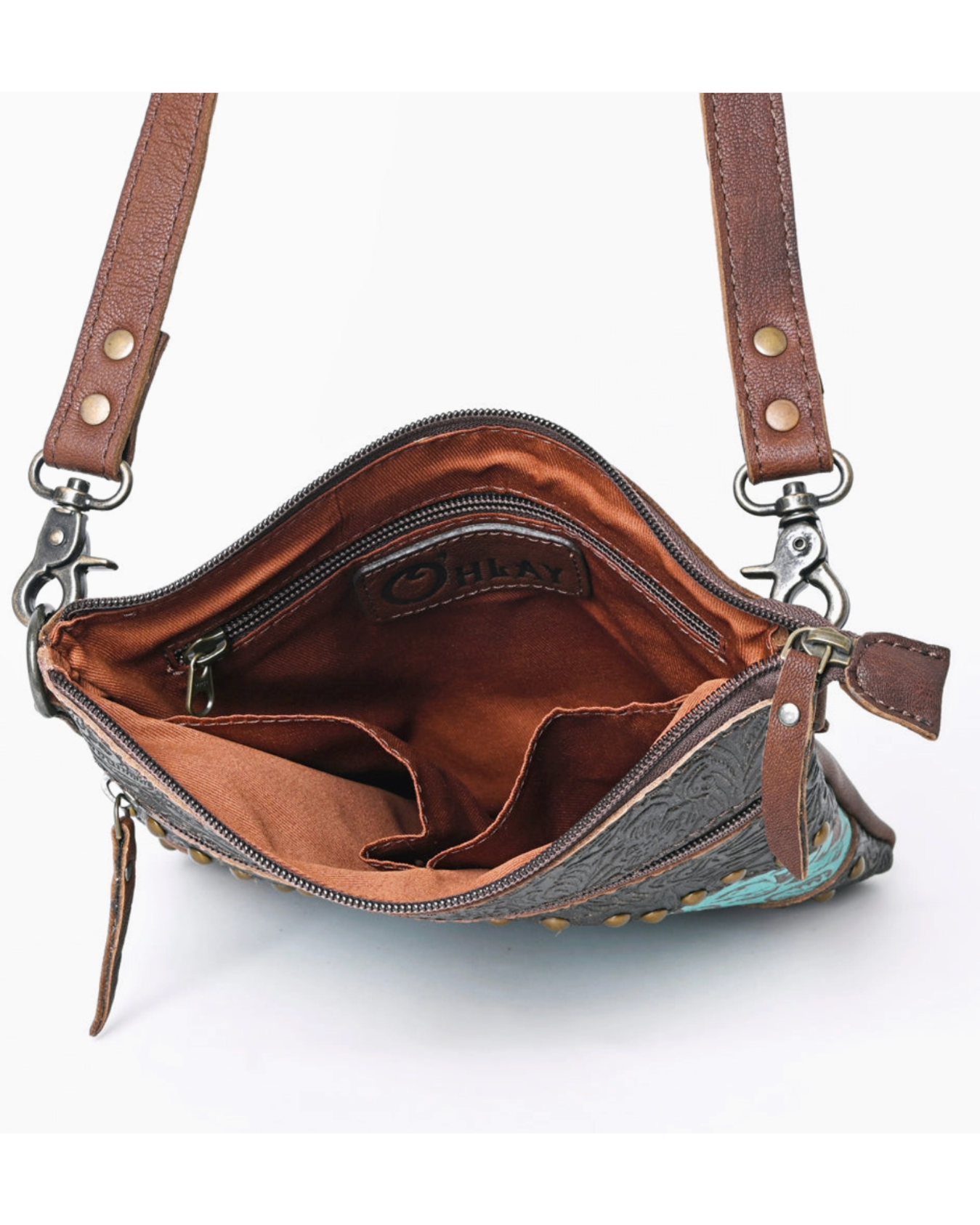 Open brown leather handbag with visible brand name on a white background