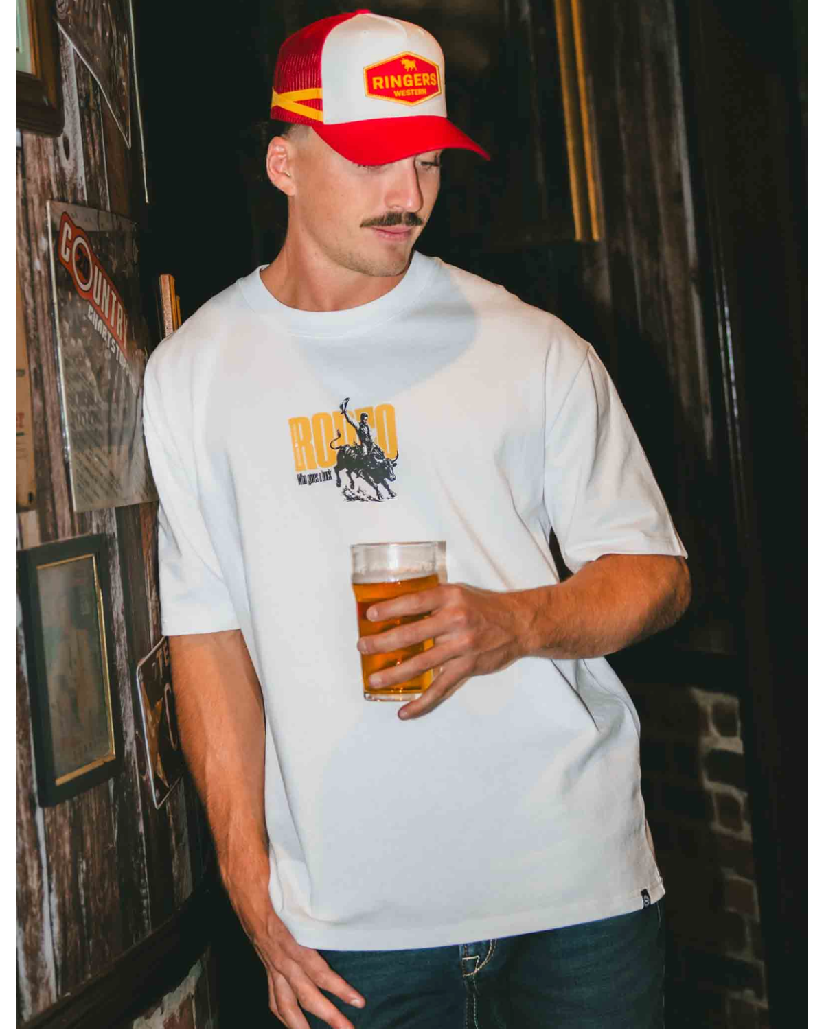 Ringers Western: Men's White Cotton Tee with a "rodeo graphic" on the front. Box Fit Tee