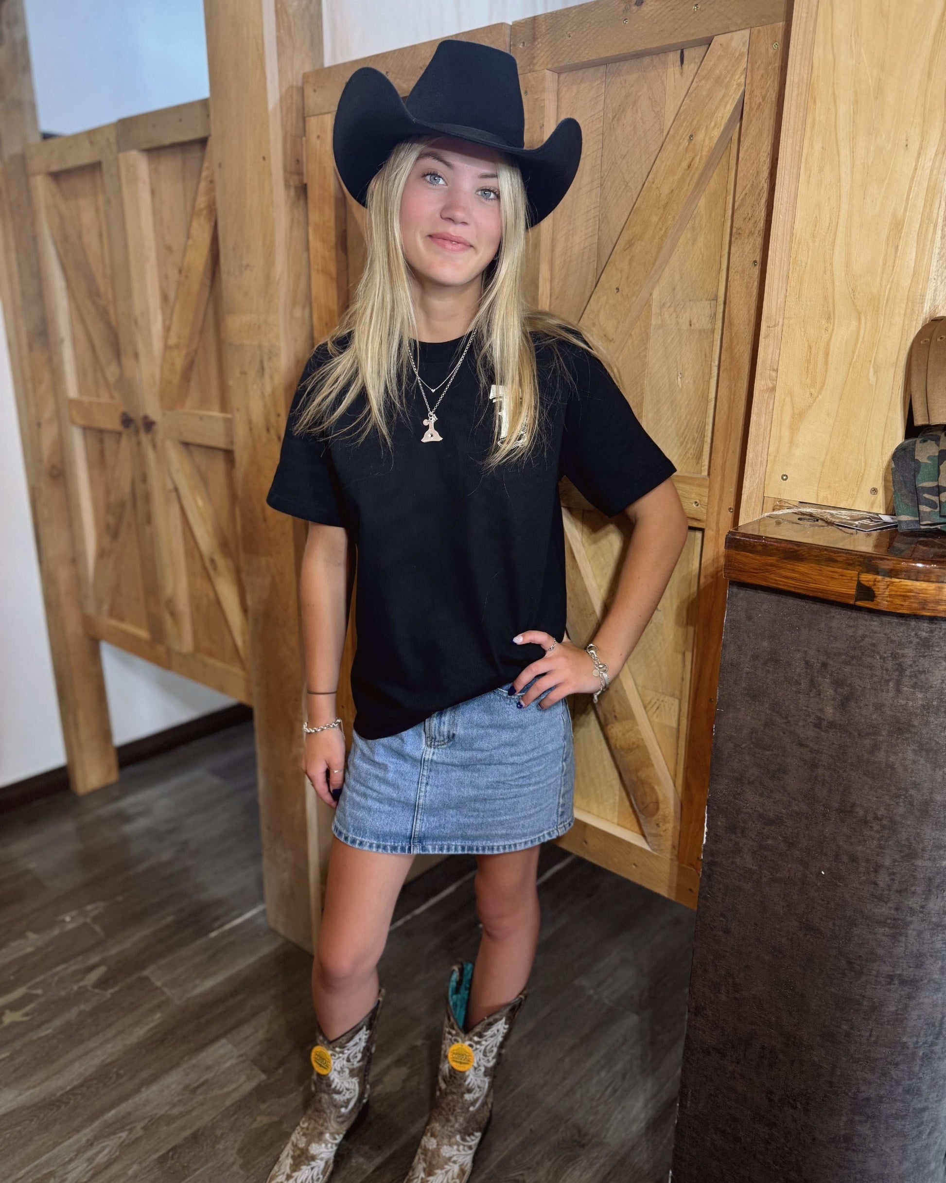 A black coloured Woman's Texas Western Apparel T-shirt with an embroidered "T" and cowboy boot on the front. The back features "Texas Western Apparel logo.