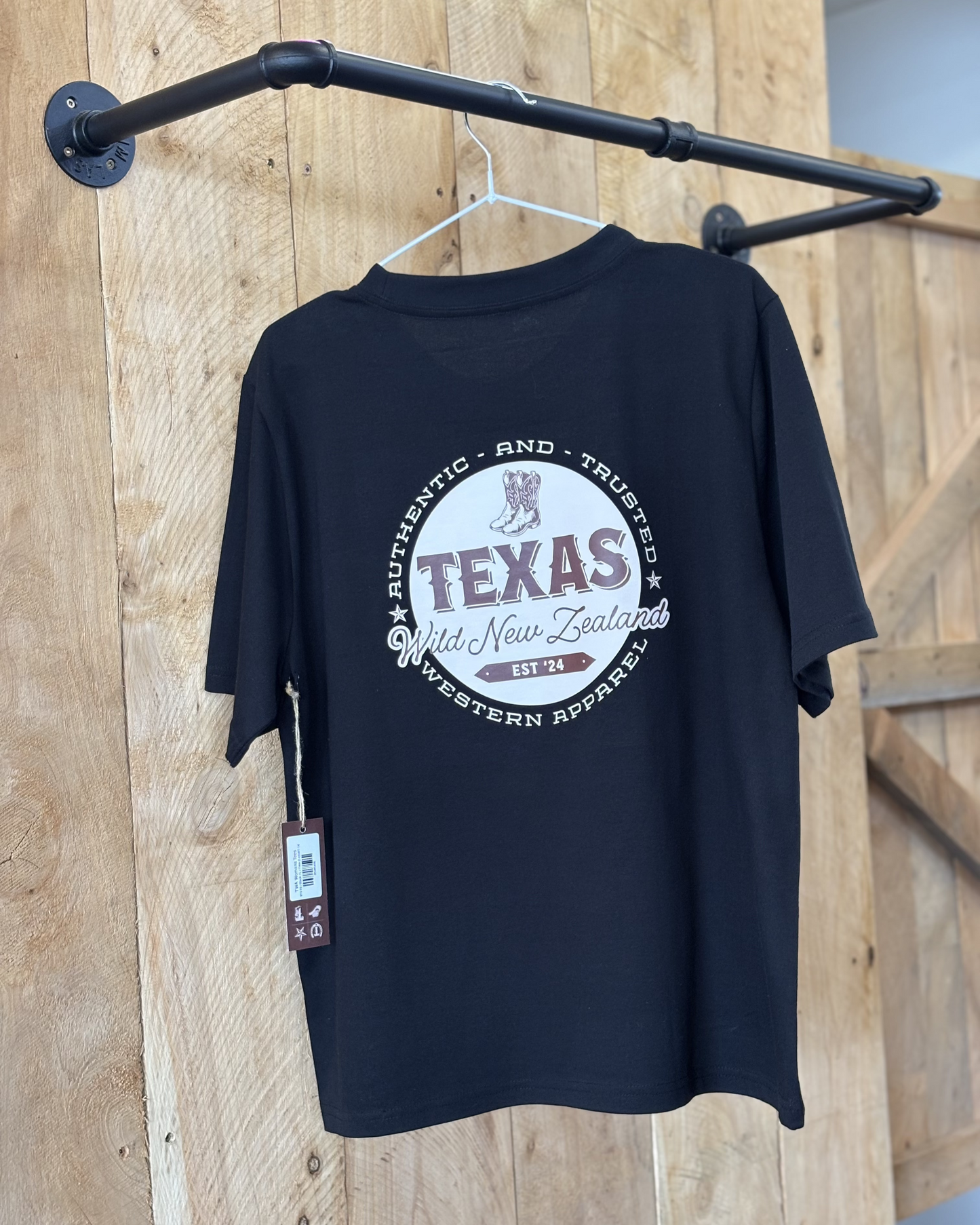 A black coloured Woman's Texas Western Apparel T-shirt with an embroidered "T" and cowboy boot on the front. The back features "Texas Western Apparel logo.