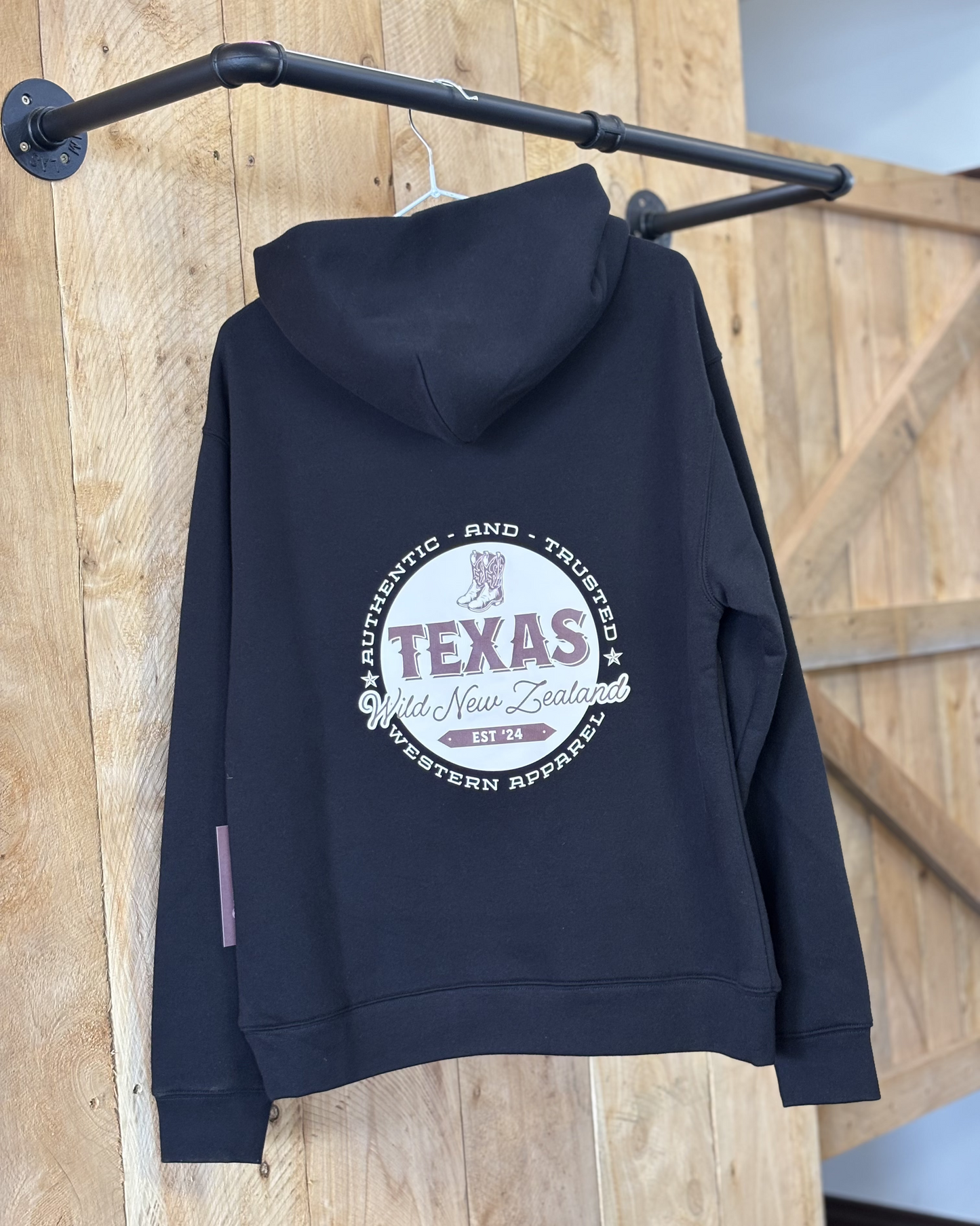 Black Texas Western Apparel hoodie with intricate embroidery. The front features a detailed embroidered 'T' and a Western-style boot, while the back showcases the Texas Western Apparel logo. A bold and stylish statement piece with a classic country flair.