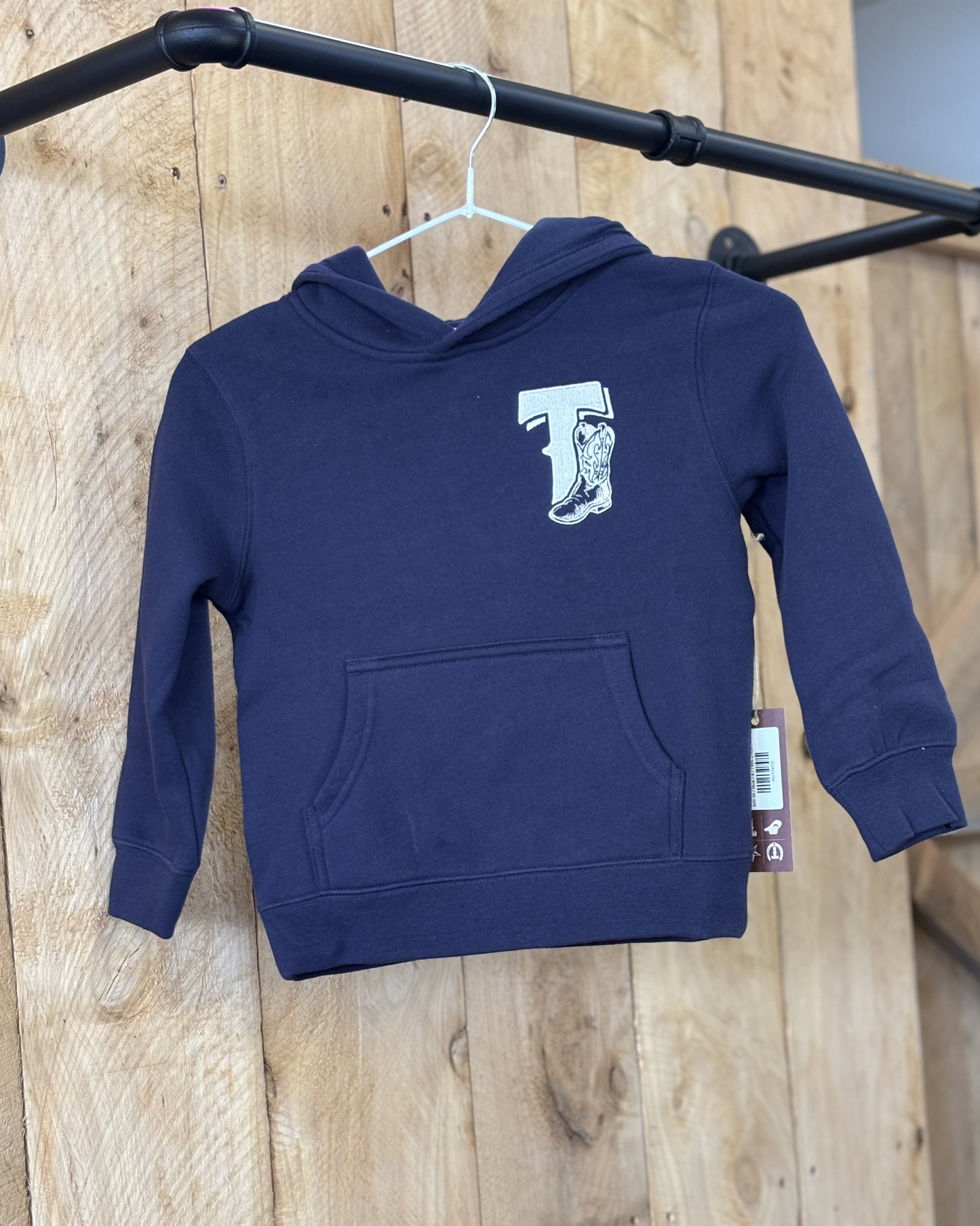 Midnight Blue Texas Western Apparel youth/kids hoodie with detailed embroidery. The front features a stitched 'T' and a Western-style boot, while the back displays the Texas Western Apparel logo. Perfect for little cowboys and cowgirls who love bold Western style!