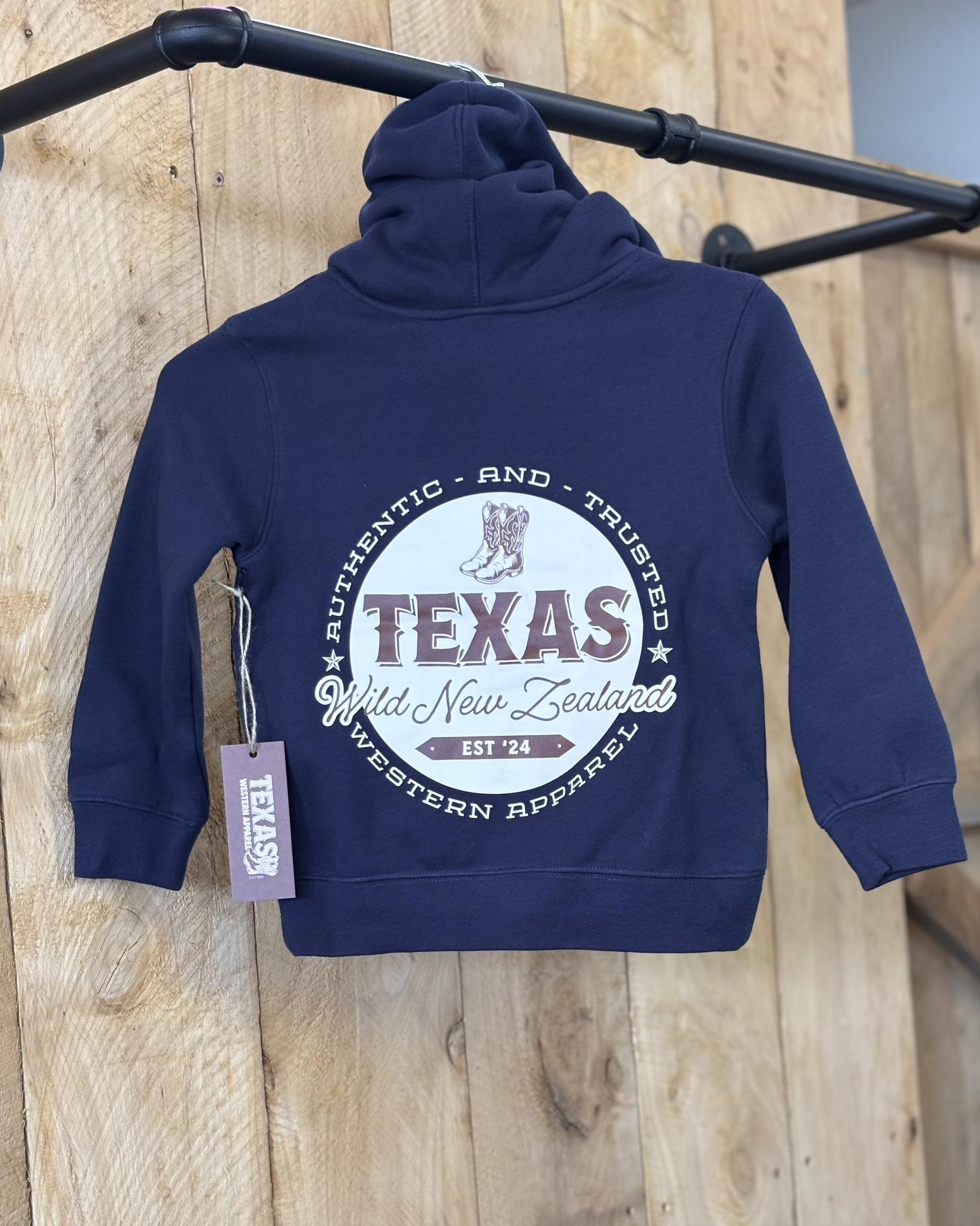 Midnight Blue Texas Western Apparel youth/kids hoodie with detailed embroidery. The front features a stitched 'T' and a Western-style boot, while the back displays the Texas Western Apparel logo. Perfect for little cowboys and cowgirls who love bold Western style!