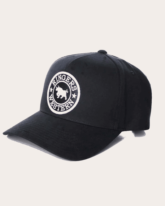 A black snapback cap featuring a structured six-panel design with a curved brim. The front panel showcases a circular embroidered patch with 'Ringers Western' text and a bull silhouette in white. The back of the cap includes an adjustable snap closure.