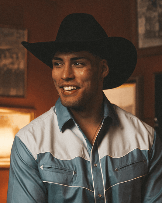 A classic black cowboy hat by Ringers Western, made of premium wool felt with a structured crown and a wide, upturned brim. A matching black hatband adds a refined touch.