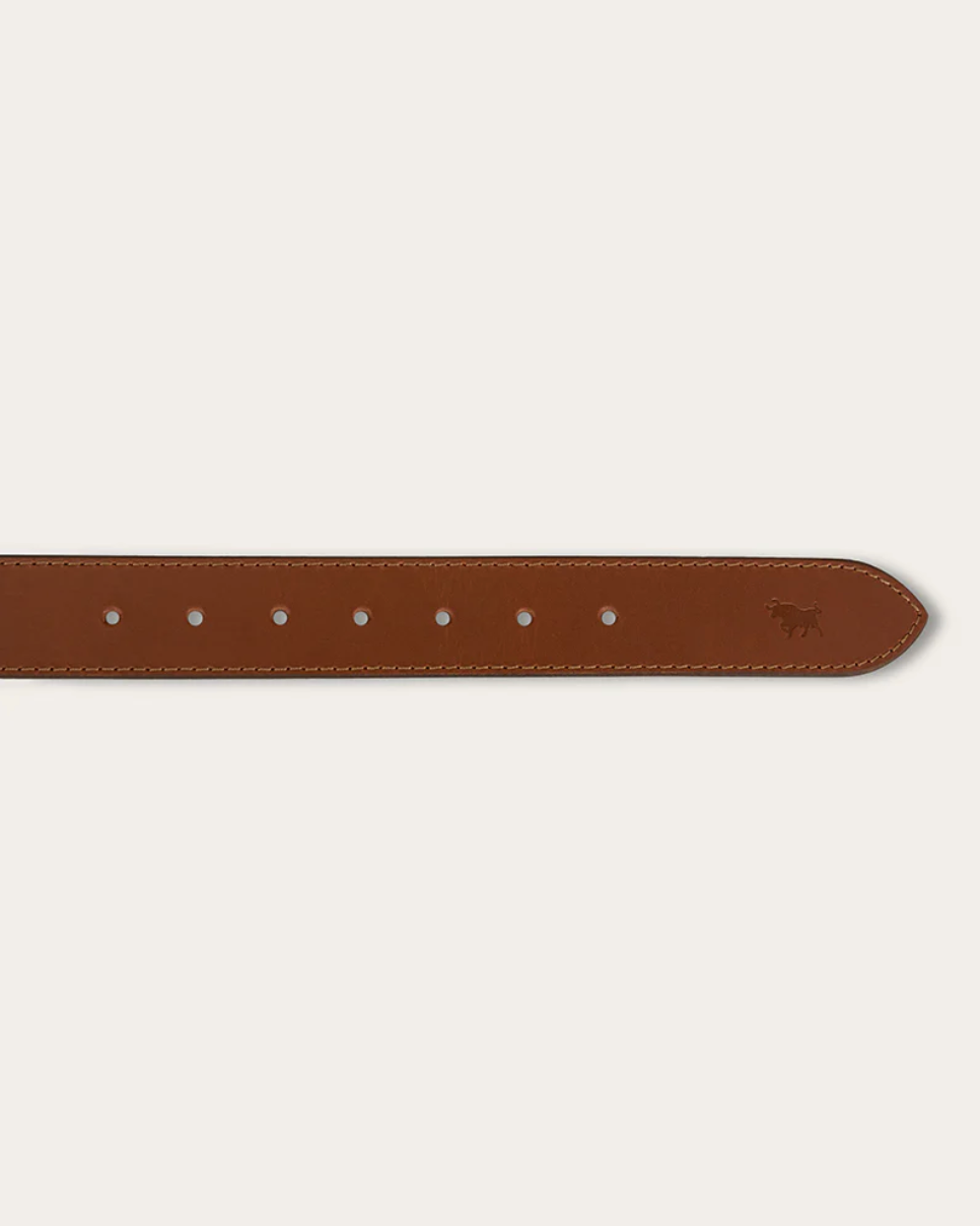 Brown leather belt with silver buckle on a beige background