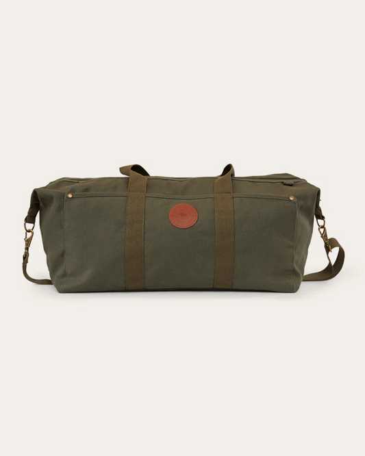 Green duffel bag with a brown leather patch on a white background