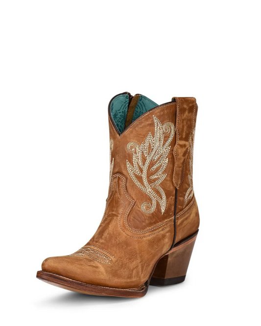 Brown cowboy boot with intricate white embroidery on a white background