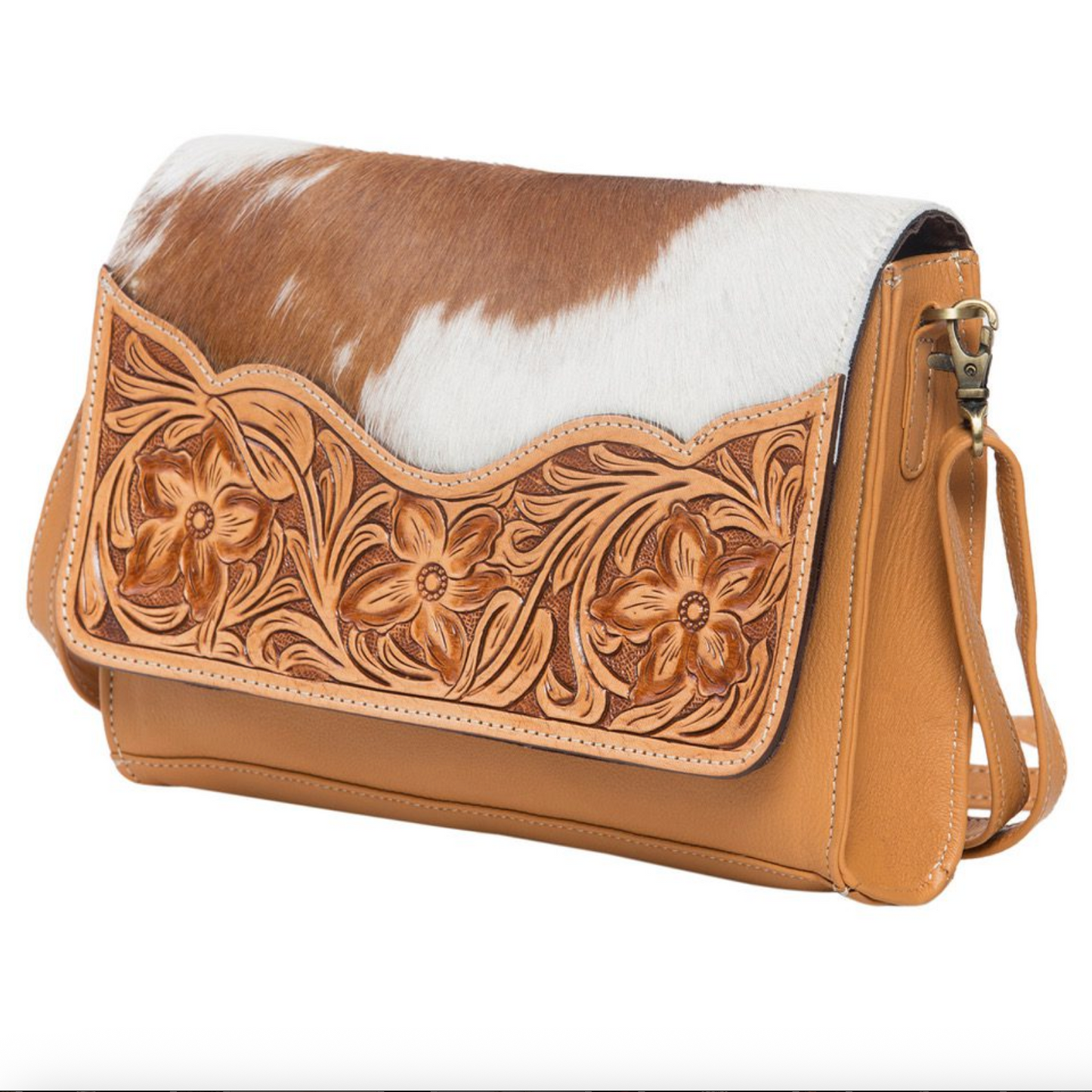 Brown and white cowhide leather handbag with floral tooled design on a white background