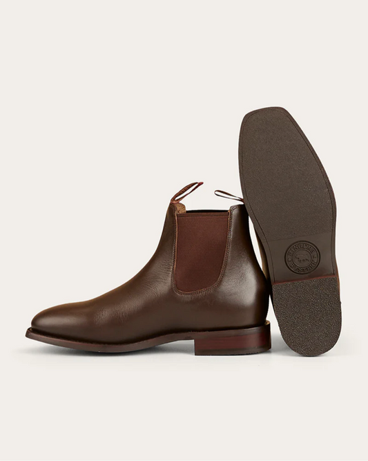 Brown leather Chelsea boot with a visible brand logo on a light gray background