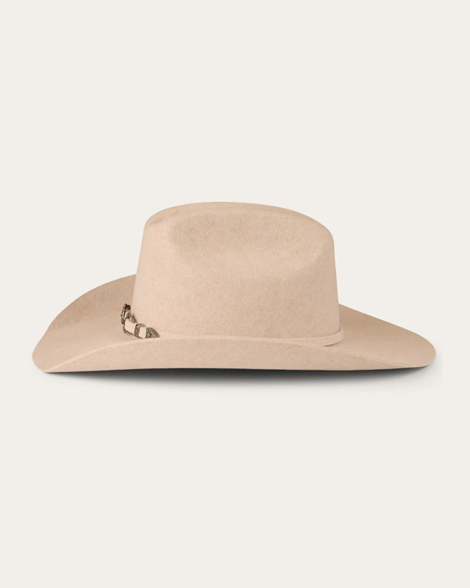 Beige cowboy hat on a light beige background