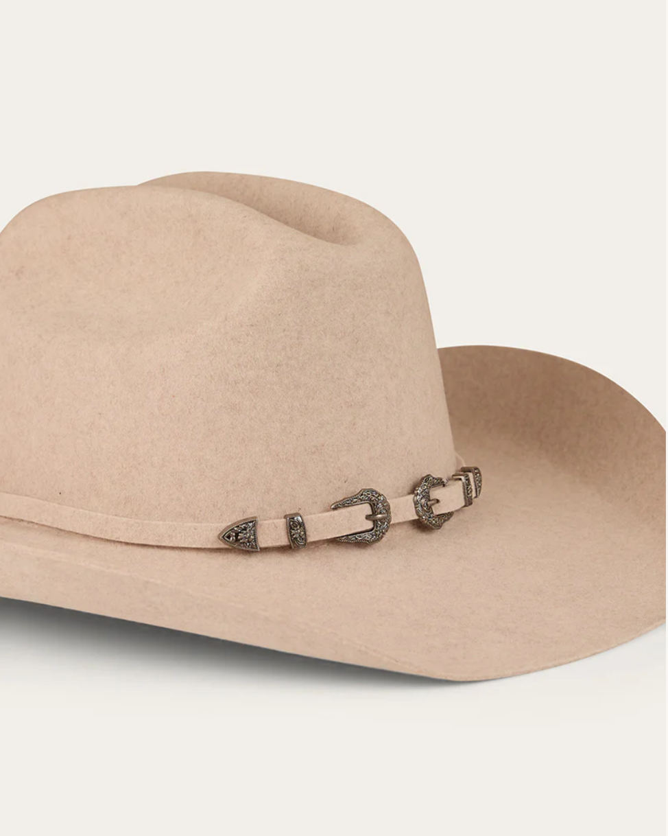 Beige cowboy hat with a decorative band on a white background