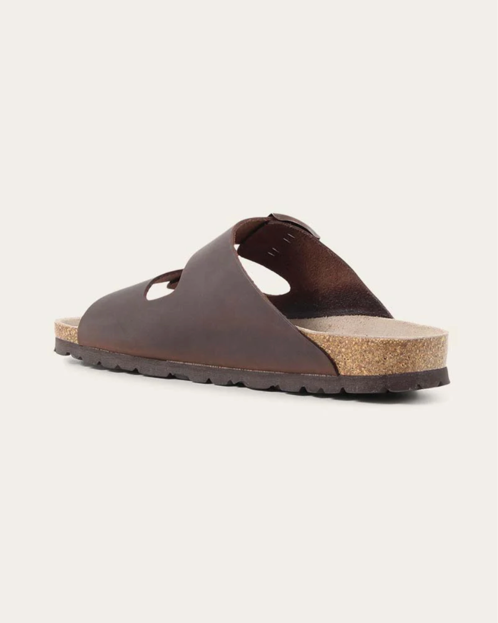 Brown sandal with cork sole on a light gray background