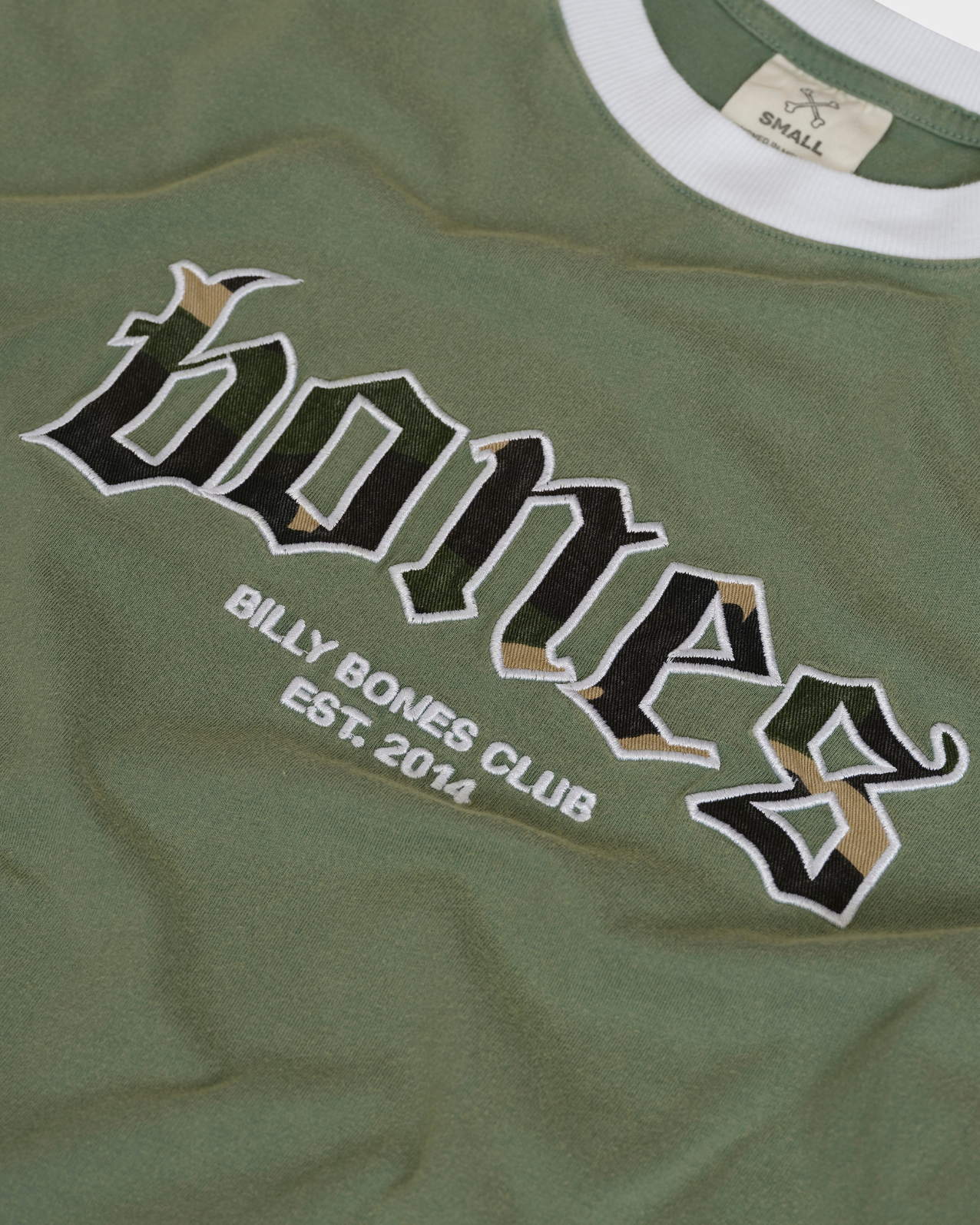 Green t-shirt with 'Bones' logo and text on a plain background