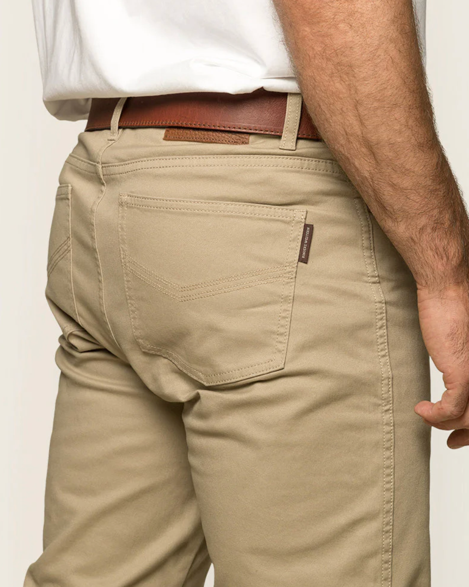 Beige pants worn by a person on a plain background