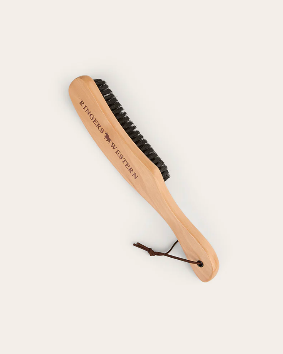 Wooden brush with black bristles on a white background