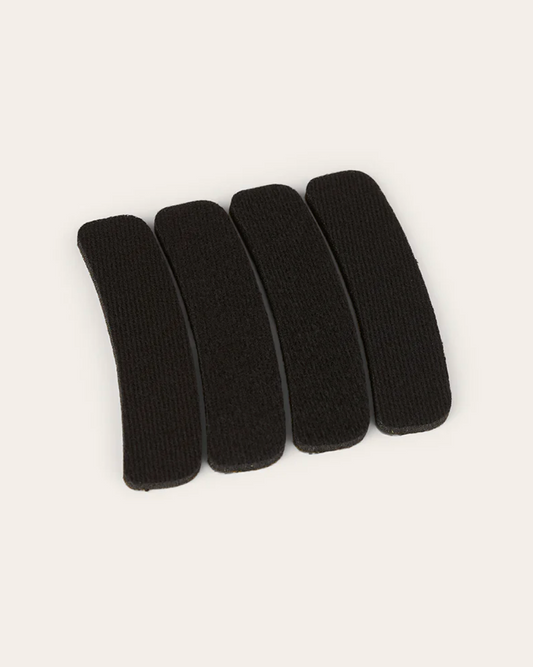 Five black hair clips arranged on a white background