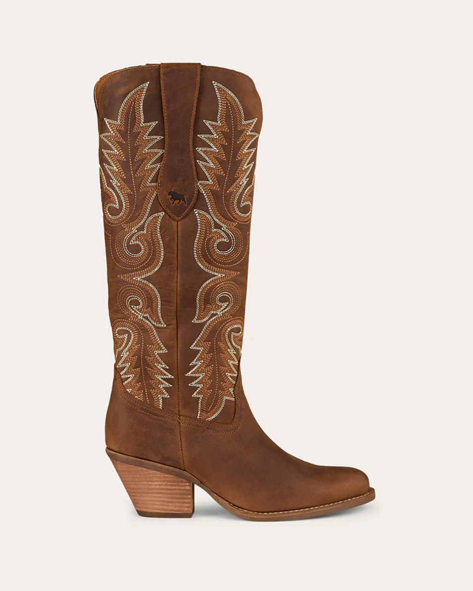 Brown cowboy boot with intricate white embroidery on a beige background
