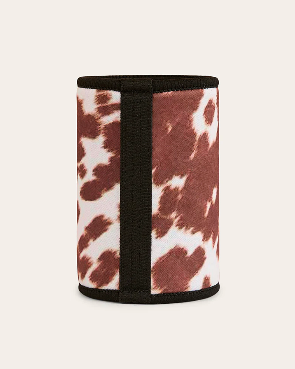 Cylindrical container with cow print pattern on a white background