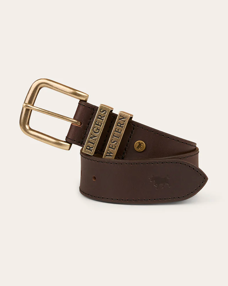 Brown leather belt with gold buckle on a light beige background