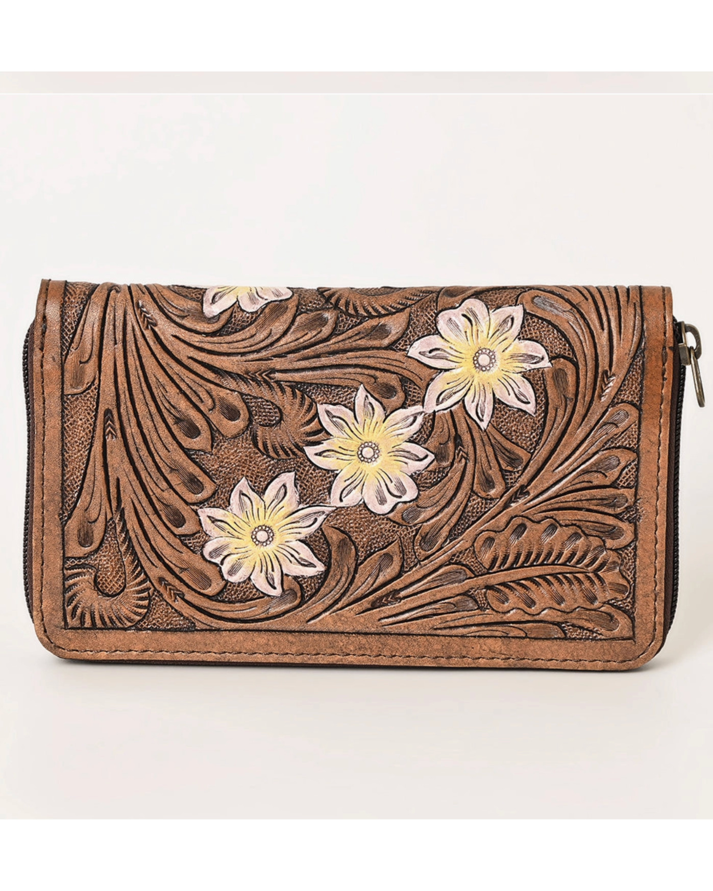 Brown leather wallet with floral designs on a white background