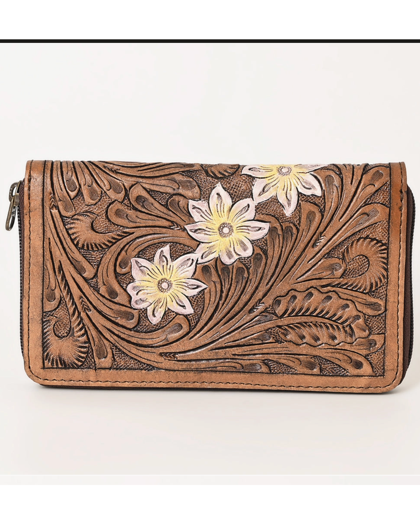 Brown leather wallet with floral designs on a white background