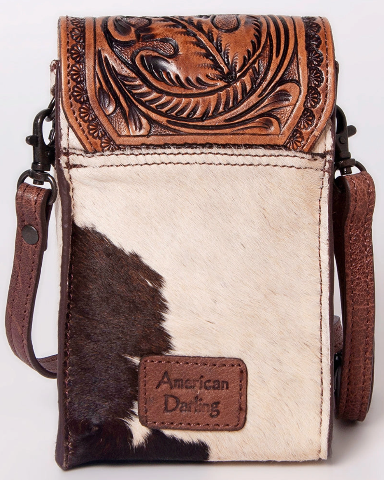Cowhide crossbody bag with intricate leatherwork on a white background