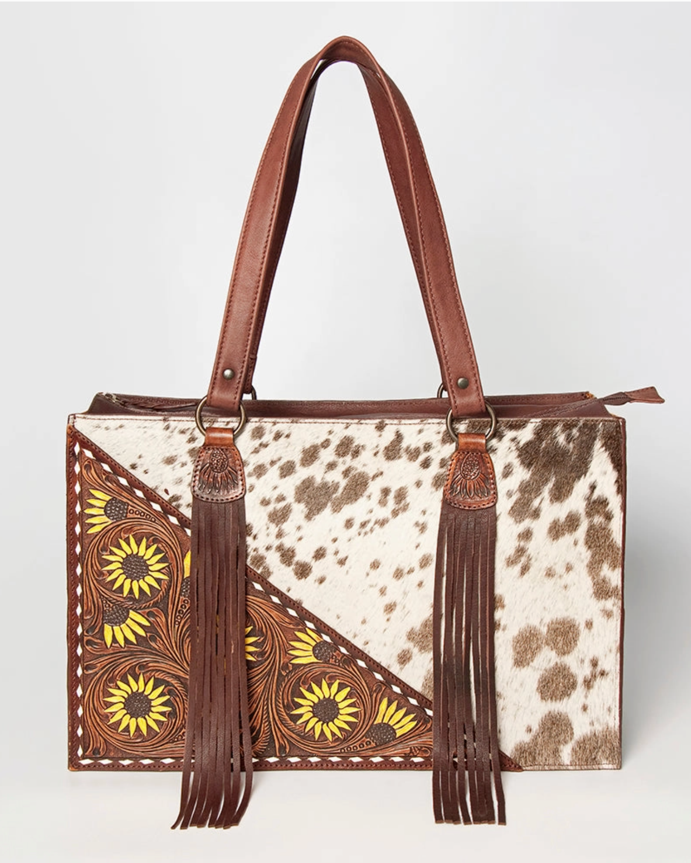 Handbag with cow print and floral patterns on a white background