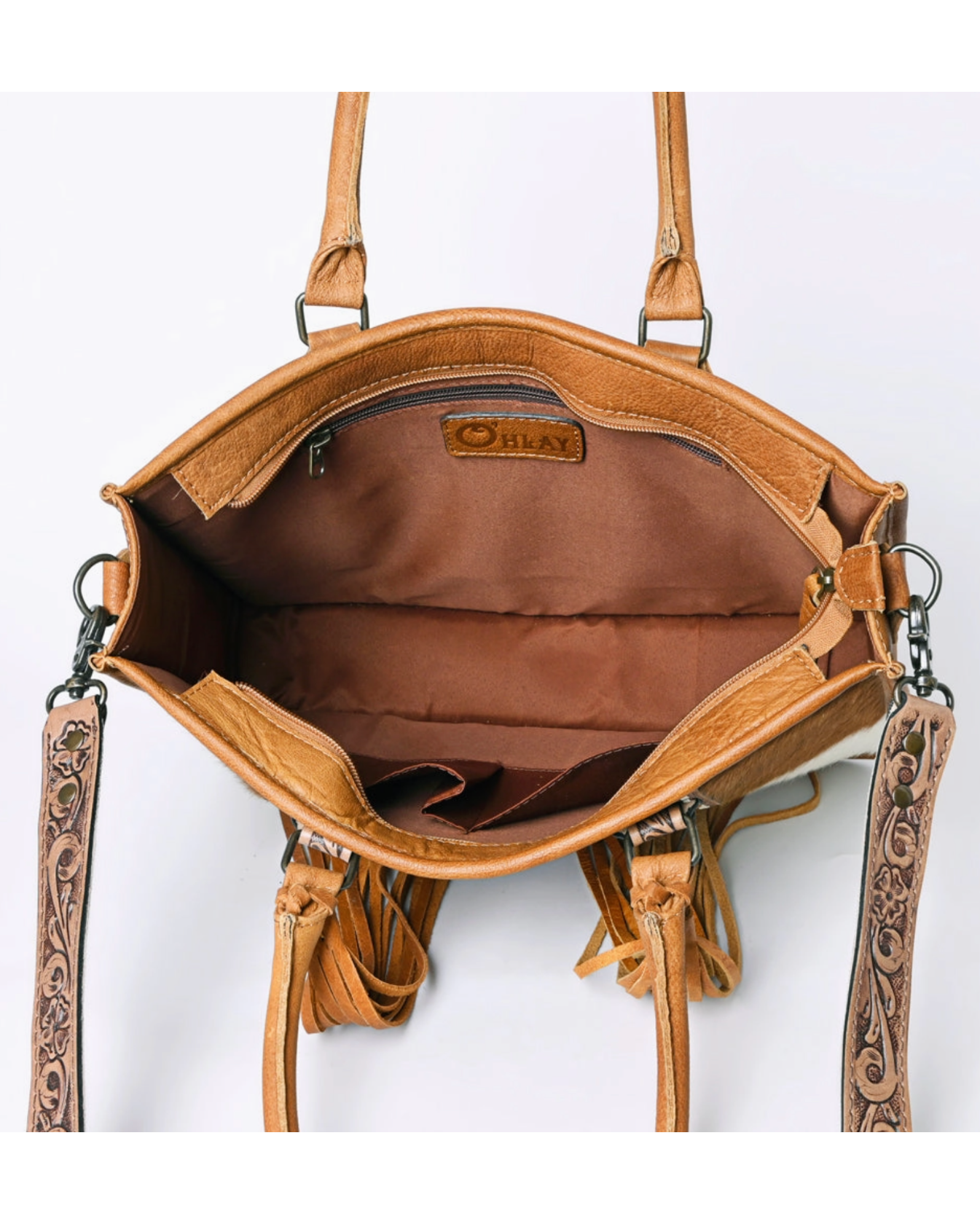 Brown leather handbag with intricate designs on a white background