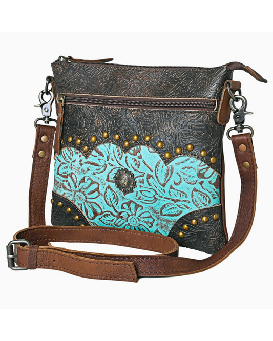 Brown leather crossbody bag with turquoise floral pattern and gold studs on a white background