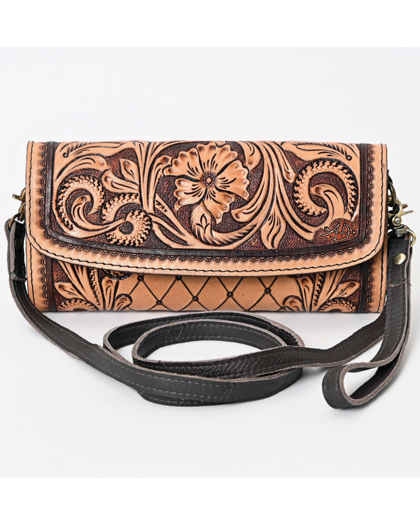 Handcrafted leather wallet with floral patterns on a white background