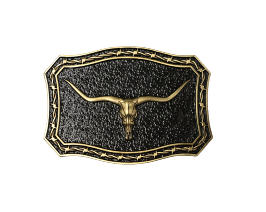 A western-style belt buckle featuring a textured black center with a gold-toned longhorn skull motif and decorative border, shown on a plain white background.