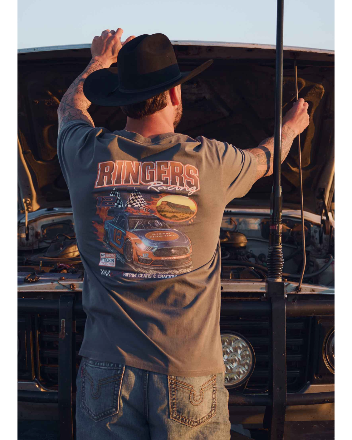 Ringers Western: Mens 100% Cotton Loose Fit Tee Shirt in the colour washed black. Featuring a race car graphic on the back of the tee and small ringers graphic on the front of the tee shirt - Texas Western Apparel New Zealand 