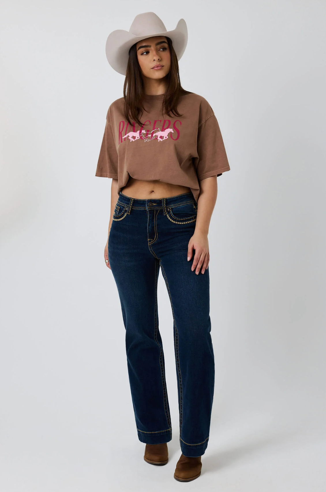 Ringers Western: Woman's 100% Cotton Brown Oversized Tee with a "Running Herd" Graphic on the front in pink - Texas Western New Zealand