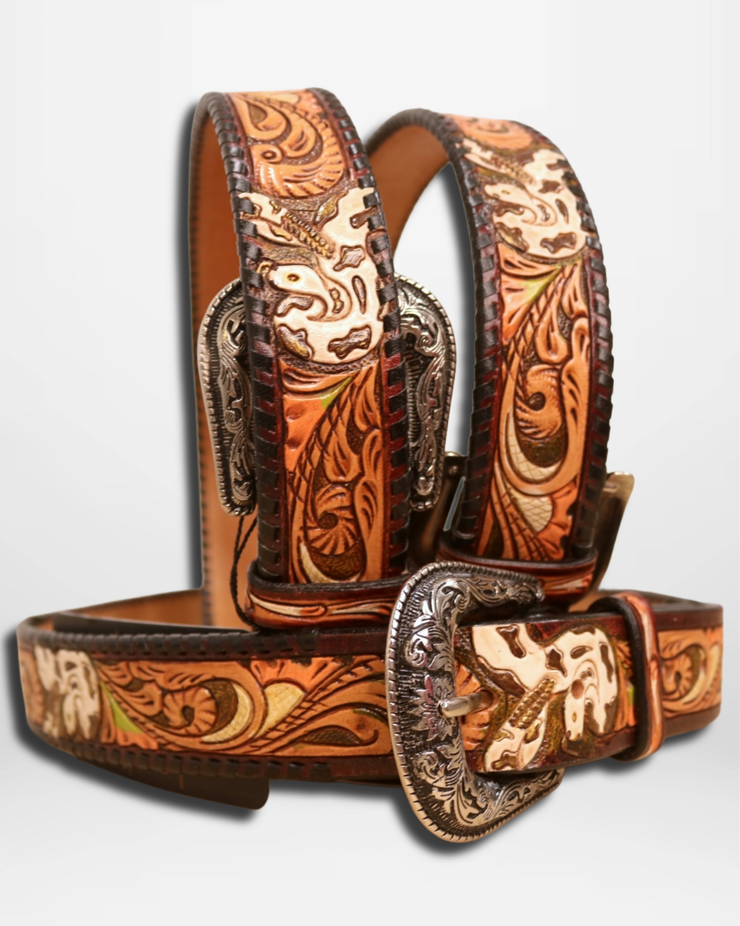 Decorative leather belt with intricate patterns and a large buckle on a light gray background