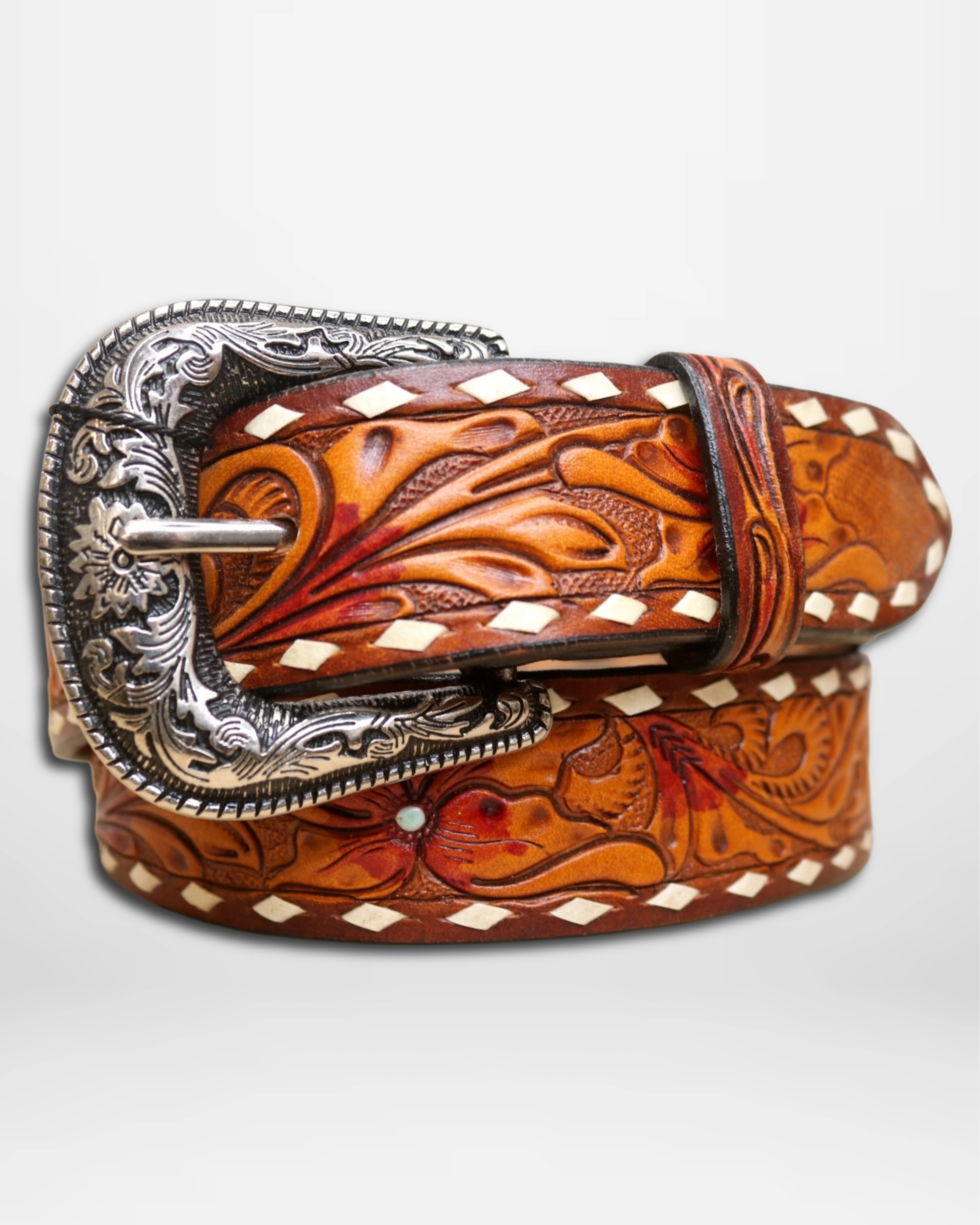 Brown leather belt with intricate silver buckle on a white background